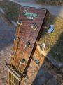 The headstock is understated, with a simple turquoise Thompson logo.